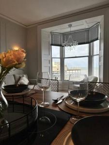 a dining room with a table with wine glasses at Luxury Seaside accommodation, Swn Y Mor in Aberystwyth