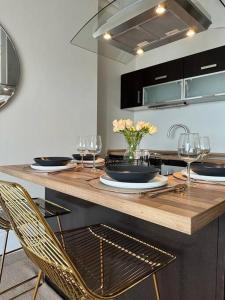 a kitchen with a table with chairs and wine glasses at Luxury Seaside accommodation, Swn Y Mor in Aberystwyth