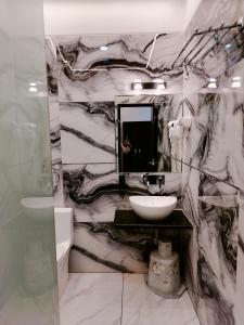 a bathroom with a black and white marble wall at Hotel Om in Betūl +49 photos