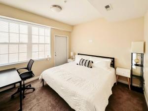 a bedroom with a bed and a desk and a chair at Luxury & Style, 3 King Bed, W/D, & FREE Garage in Schenectady