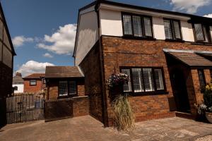 a brick house with a door and a window at Inviting 3-Bed House in Manchester in Manchester