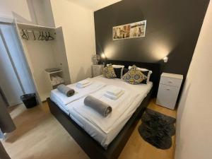 a bedroom with a bed with white sheets and pillows at City West Studios in Stuttgart +9 photos