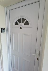 a white door with a window on top of it at OASIS APARTMAN II. in Szeged