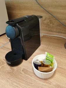 a coffee maker sitting next to a bowl of food at OASIS APARTMAN II. in Szeged +15 photos