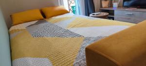 a bed with a colorful quilt on top of it at Ca' Balenga - Cozy Stay in the Old Town with Free Private Parking in Asti