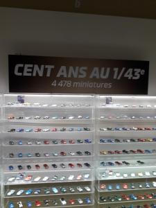 a display case filled with lots of toy cars at Proximite circuit 24 heures in Le Mans