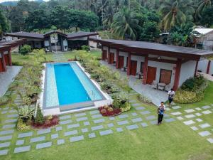 an aerial view of a house with a swimming pool at Swissfinity Beach Resort in Pangubatan