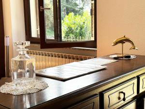 a glass bottle on a counter with a window at Incanto in Nesso