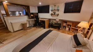 a bedroom with a large bed and a kitchen at Logement vue sur la seine in Boulogne-Billancourt