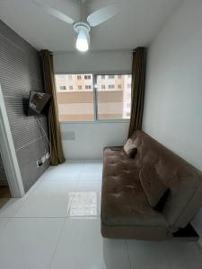 a living room with a couch and a window at Apartamento Barra Funda - 202 in Sao Paulo
