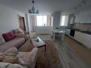 a living room with a couch and a table at MIRO HOUSE in Bucharest