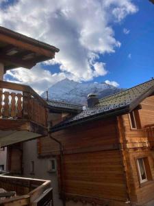 a view of the mountains from the roof of a house at Appartement at the heart of Saas Fee in Saas-Fee
