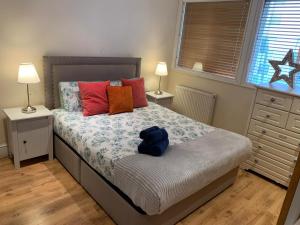 a bedroom with a bed with a blue backpack on it at Lovely flat in West Kensington Central London in London