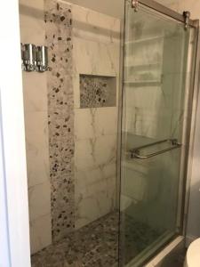 a shower with a glass door in a bathroom at Beaches are Open-St Augustine in Saint Augustine