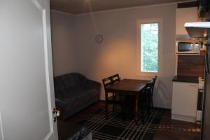 a living room with a table and a couch at Oulunsalo Apartment in Oulunsalo