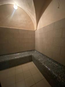 a bathroom with a tub with a light on the ceiling at City Business Monastir Center in Monastir