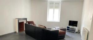 a living room with a couch and a tv at Appartement centre ville in Châteauroux
