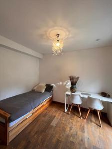 1 dormitorio con 1 cama, mesa y sillas en Chambre privée Toulouse proche métro et rocade en Toulouse