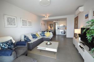 a living room with a couch and a table at Penthouse Apartment Tejita Beach in La Tejita