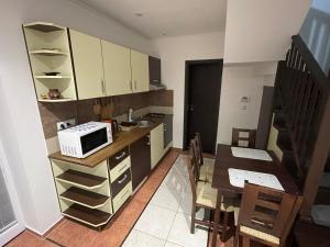 a small kitchen with a table and a microwave at RRR Apartmány in Bojnice