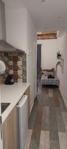 a kitchen with a counter and a living room at City Center Guest house in Valencia