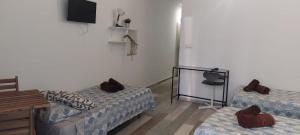 a living room with two beds and a television at City Center Guest house in Valencia