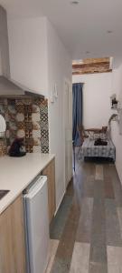 a kitchen with a counter and a living room at City Center Guest house in Valencia