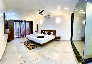 1 dormitorio con 1 cama y ducha acristalada en Shivsagar Agro Tourism, Tapola, en Mahabaleshwar