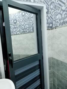 a glass door to a shower in a bathroom at Onaty Narty Guest house Nile view in Aswan +111 photos