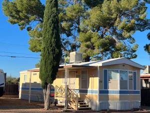 a yellow caravan parked in front of a tree at Stampede RV B&B in Tombstone