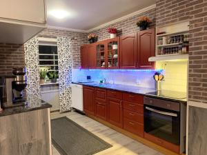 a kitchen with red cabinets and a brick wall at Fin Villa nära insjön Burtäsket in Burträsk