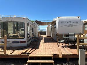 an rv and a patio with a table and chairs at Stampede RV B&B in Tombstone