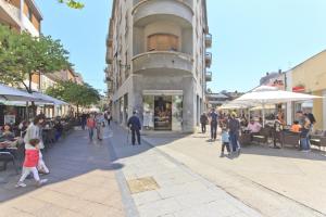 a group of people walking on a city street at Spacious & Smart Center Apartment in Pula