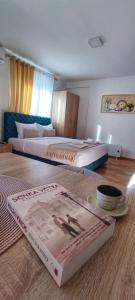 a hotel room with two beds and a book on the floor at Soko City Center & Parking Free in Soko Banja