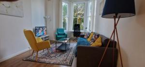 a living room with a couch and two chairs at Primrose Hill - Charming, Cosy, 2 Double Bedrooms Apartment in London