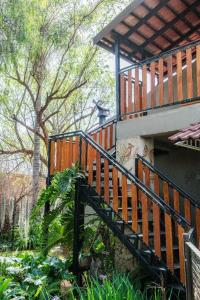 a wooden staircase leading up to a building with trees at Edwil's Place in Hartbeespoort