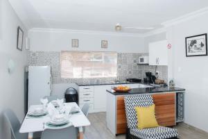 a kitchen with a table and a dining room at Edwil's Place in Hartbeespoort