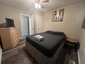 a bedroom with a bed and a flat screen tv at Quiet Munster Ranch Near Franciscan Hospital in Munster