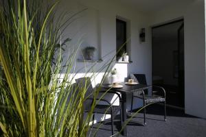 a dining room with a table and chairs and plants at Haus Anna-Marie in Feldberg