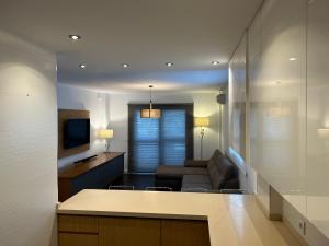 una cucina e un soggiorno con divano e TV di Puertito Beach Suites 1 a Puertito de Güímar