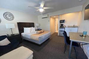 a hotel room with a bed and a kitchen at Beachside Resort Motel in St Pete Beach