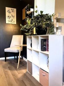 a room with a book shelf with plants on it at The Getaway at Palm Dr in Atlanta