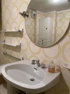 a bathroom with a sink and a mirror at NIGRITELLA in Madonna di Campiglio