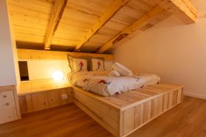 a bed in a room with a wooden floor at Duplex 65 m2 au coeur du golf de Tignes in Tignes
