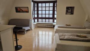 a living room with a couch and a chair at 2,5 Zimmerwohnung in Mönchengladbach