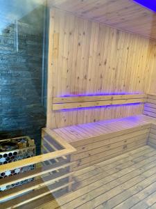 a wooden sauna with a bench and wine bottles at Apartamento Special For You in Cartagena de Indias