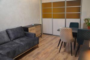 a living room with a couch and a table and chairs at Apartment in Vilnius in Vilnius