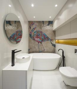 ノヴィサドにあるSky-High Luxury - City's Best Viewのバスルーム(バスタブ付)が備わります。壁に鳥が1羽