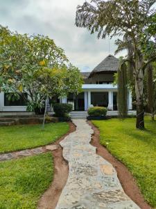 a stone path leading to a house at WHITE Nyumba in Malindi