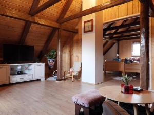 a large living room with a television and a table at Kuća za odmor Elf in Kupjak